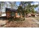 Side view of a traditional brick home with green shutters and mature trees at 1120 Crestview Ave, Salisbury, NC 28144