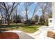 Expansive backyard featuring lush greenery, mature trees, and a pathway leading to the house at 1201 Edgefield Ave, Gastonia, NC 28052