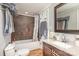 Cozy bathroom featuring a tiled shower and dark wood vanity with marble countertop at 1201 Edgefield Ave, Gastonia, NC 28052