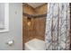 Shower and tub combination featuring stylish tiled shower and marble curtain at 1201 Edgefield Ave, Gastonia, NC 28052