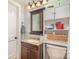 Cozy bathroom with storage cabinet, vanity, and a well-lit mirror at 1201 Edgefield Ave, Gastonia, NC 28052