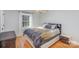 Bright bedroom features hardwood floors, neutral walls, and a window providing natural light at 1201 Edgefield Ave, Gastonia, NC 28052