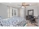 Cozy bedroom with light walls, ceiling fan, and dark wood desk with keyboard at 1201 Edgefield Ave, Gastonia, NC 28052