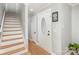 Bright entryway featuring hardwood floors, stairs to the second floor, and a decorative front door at 1201 Edgefield Ave, Gastonia, NC 28052