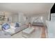 Spacious living room featuring hardwood floors, a gray sofa, and a white coffee table at 1201 Edgefield Ave, Gastonia, NC 28052