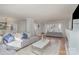 Spacious living room featuring hardwood floors, a gray sofa, and a white coffee table at 1201 Edgefield Ave, Gastonia, NC 28052