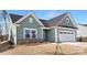 Charming one-story home with a two-car garage and landscaped yard, set against a blue sky at 134 Montgomery Pl # 708, Mount Gilead, NC 27306