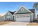 Inviting one-story home with a two-car garage, brick accents, and manicured lawn at 134 Montgomery Pl # 708, Mount Gilead, NC 27306