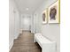 Hallway with wood floors and modern art leading to the front door and other rooms at 134 Montgomery Pl # 708, Mount Gilead, NC 27306