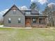 Charming gray two-story home with covered front porch and beautiful wood and brick accents at 1467 Centennial Dr, Rock Hill, SC 29732