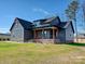 Gray two-story home with a covered front porch, brick accents, and lush green lawn at 1467 Centennial Dr, Rock Hill, SC 29732