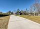 Long driveway leads to this two-story home with a large front lawn surrounded by trees at 1467 Centennial Dr, Rock Hill, SC 29732