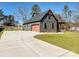 Side view of home with a garage and long driveway surrounded by a spacious lawn at 1467 Centennial Dr, Rock Hill, SC 29732