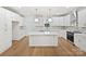 Bright kitchen features white cabinets, stainless steel appliances, stylish backsplash, and a large center island at 1467 Centennial Dr, Rock Hill, SC 29732