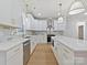 Modern kitchen boasts white cabinets, stone backsplash, stainless steel appliances, and island with bar seating at 1467 Centennial Dr, Rock Hill, SC 29732