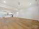 Spacious living room with hardwood floors, white trim, and view of the kitchen at 1467 Centennial Dr, Rock Hill, SC 29732
