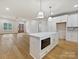 Open-concept living space with hardwood floors, island kitchen, and access to a covered outdoor area at 1467 Centennial Dr, Rock Hill, SC 29732