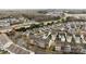 Wide aerial captures townhomes with manicured lawns, tree-lined streets, and nearby amenities in a community at 15662 King Louis Ct, Charlotte, NC 28277