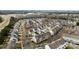 Extensive aerial view displaying a community with townhomes, tree-lined streets, and manicured lawns at 15662 King Louis Ct, Charlotte, NC 28277