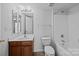 Neutral bathroom featuring a tub with shower, single sink vanity, toilet, and light walls at 15662 King Louis Ct, Charlotte, NC 28277
