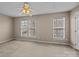Bedroom features two large windows, carpet, ceiling fan, and neutral walls at 15662 King Louis Ct, Charlotte, NC 28277