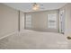 Bright and airy bedroom with neutral carpet, ceiling fan, and natural light from two windows at 15662 King Louis Ct, Charlotte, NC 28277