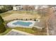 The community pool has a cover with a surrounding fence, a nearby parking lot, and a pool house at 15662 King Louis Ct, Charlotte, NC 28277