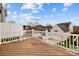 Elevated view of neighborhood from wood deck featuring white railing at 15662 King Louis Ct, Charlotte, NC 28277