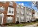 Townhome exterior with brick and siding, showcasing well-kept landscaping, and a charming entrance at 15662 King Louis Ct, Charlotte, NC 28277