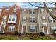Townhome exterior showcasing a mix of brick and siding, complemented by tidy landscaping and inviting entrances at 15662 King Louis Ct, Charlotte, NC 28277