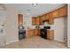 Kitchen featuring tile flooring, wooden cabinets, and stainless steel appliances at 15662 King Louis Ct, Charlotte, NC 28277