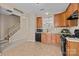 Kitchen featuring tile flooring, wooden cabinets, and stainless steel appliances at 15662 King Louis Ct, Charlotte, NC 28277