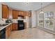 Kitchen featuring tile flooring, dark countertops, and stainless steel appliances at 15662 King Louis Ct, Charlotte, NC 28277