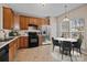 Kitchen with stainless steel appliances, warm wood cabinets, and an adjacent dining area at 15662 King Louis Ct, Charlotte, NC 28277