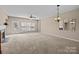 Large, open living room featuring a fireplace, a ceiling fan, and backyard access at 15662 King Louis Ct, Charlotte, NC 28277