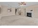 Open concept living room with fireplace, ceiling fan, and stairway to the second floor at 15662 King Louis Ct, Charlotte, NC 28277