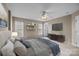 Main bedroom with ceiling fan, TV, and plush bedding at 15662 King Louis Ct, Charlotte, NC 28277