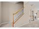Carpeted staircase with white spindles and wood handrail leading to the upper level of the home at 15662 King Louis Ct, Charlotte, NC 28277
