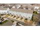 An aerial view of townhomes with private decks, garages, and driveways in a residential community at 15662 King Louis Ct, Charlotte, NC 28277