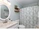 This bathroom has a toilet, sink, vanity, mirror, shower, and stylish floral shower curtain at 1597 Mcgill St, Rock Hill, SC 29732