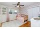 Charming bedroom features a daybed, hardwood floors, a ceiling fan, and a closet for ample storage at 1597 Mcgill St, Rock Hill, SC 29732
