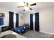 Cozy bedroom featuring hardwood floors, a ceiling fan, and dark blue curtains on the bright windows at 1597 Mcgill St, Rock Hill, SC 29732