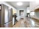 Well-lit kitchen with stainless steel appliances, tile floors, and white cabinets at 1597 Mcgill St, Rock Hill, SC 29732