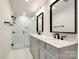 Modern bathroom features a glass enclosed shower, double vanity, and updated light fixtures at 16137 Tana Tea Cir, Tega Cay, SC 29708