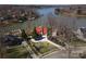 Scenic aerial view of a waterfront home with a private dock, manicured lawns, and beautiful lake views on a sunny day at 170 W Maranta Rd, Mooresville, NC 28117