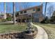 Brick home featuring a fountain, lush lawn, and a serene, treelined backyard at 170 W Maranta Rd, Mooresville, NC 28117