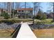 Rear view of home with an in-ground dock and a beautiful, serene backdrop at 170 W Maranta Rd, Mooresville, NC 28117