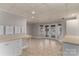 Basement area with tile floor, double doors to the lake, built-in desk and neutral decor at 170 W Maranta Rd, Mooresville, NC 28117