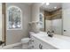 Well-lit bathroom featuring a vanity, toilet, window, and a glass-enclosed shower for a spa-like experience at 170 W Maranta Rd, Mooresville, NC 28117