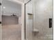 Marble shower with seat and glass door, leading into bedroom at 170 W Maranta Rd, Mooresville, NC 28117